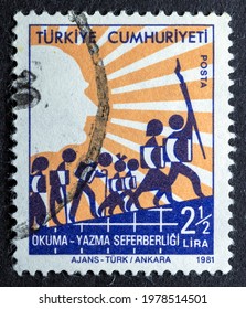 MADRID, SPAIN - MAT 22, 2021. Vintage Stamp Printed In Turkey Shows Reading Writing Campaign, People Of Various Ages With A Book Going Up A Hill