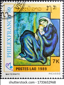 MADRID, SPAIN - MAY 17, 2020. Vintage stamp printed in Laos shows Motherhood, Maternity, painted by Picasso, a Spanish painter who spent most of his adult life in France