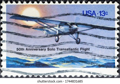 MADRID, SPAIN - MAY 17, 2020. Vintage Stamp Printed In USA Shows 50th Anniversary Solo Transatlantic Flight. On May 21, 1927, Lindbergh, Flying His Spirit Of St. Louis From New York To Paris