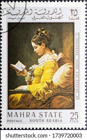 MADRID, SPAIN - MAY 22, 2020. Vintage Stamp Printed In Mahra State Shows A Young Girl Reading Painted By Jean-Honore Fragonard, A French Painter