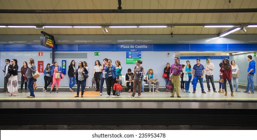 MADRID, SPAIN - MAY 28, 2014: Tube, underground station with commuters awaiting train