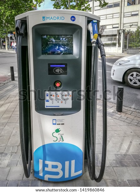 Madrid / Spain - May 7, 2019:  A\
charger for electric vehicles in Paseo De La Castellana\
street