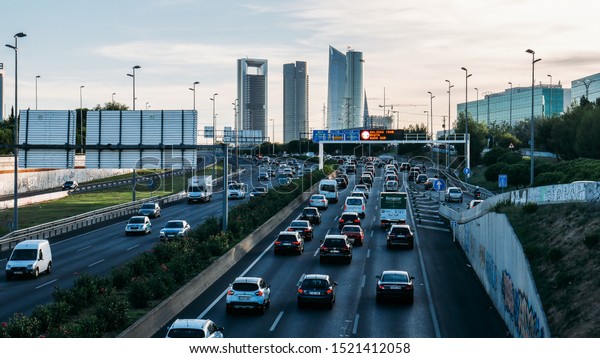 Madrid, Spain - Oct 3, 2019: Heavy commuter\
highway traffic on the A1 highway in Las Tablas looking towards the\
Cuatro Torres Business\
district