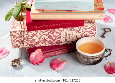 Madrid, Spain - September 2, 2020: Books by Jane Austen and about her in a stack, with a tea cup and some vintage objects, illustrative editorial