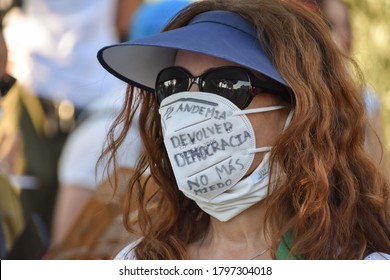 Madrid/Spain, 2020-08-16 Demonstration Against Government Restrictions Due To The Covid19. A Redhead Woman Wears A Mask That Reads: 