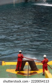 Madura, October 2022. The Ship's Crew Is Spraying Fire Hydrate On The Towing Wire To Clean The Remaining Mud On The Wire During Pay-in (Spooling) Towing Wire