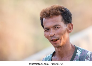 MAE SOT, TAK, THAILAND - APRIL 19, 2016 : Unidentified Myanmar Man Is Posing Show Teeth Black Chewing Betel Nut, Rim Moei, Mae Sot, Tak, Thailand.