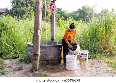 MAE SOT, TAK, THAILAND - MAY 09, 2017 : Unidentified Myanmar woman live along the border Thailand - Myanmar is taking water from the pond for household use at Ban Tha Aad, Mae Sot, Tak, Thailand.