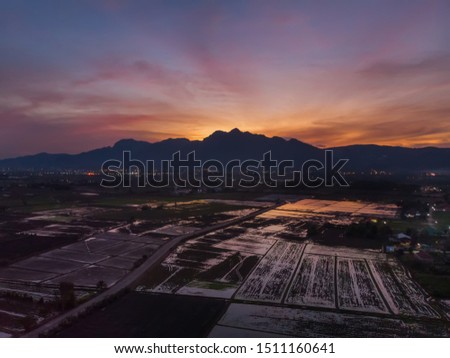 Maesai Chiangrai Thailand aerial view cityscape by drone.Scenics view maesai district skyline before sunset landscape with doi nang non mountain range