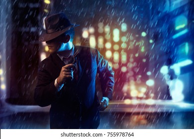 Mafia Man With Money, Gun, Hat  Red Tie Searching Enemies On Noir City Lights Night Background.