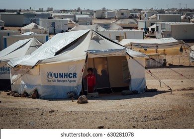 Mafraq, Jordan - June 2, 2014 : Syrian Child Standing Outside Her Tent At The Zaatari Refugee Camp In Mafraq, Jordan.