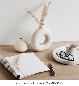 Magazin Blank Mockup With Copy Space. Home Desk Workspace With Modern Vase,marble Tray, Glasses, Pen, Coffee Cup  On Beige Wooden Table.  Minimalist Lifestyle Neutral Color.