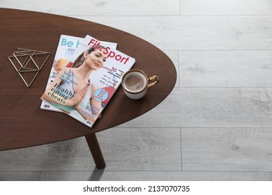 Magazines And Cup Of Coffee On Wooden Table Indoors, Above View. Space For Text