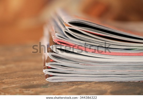 Magazines on the wooden\
table