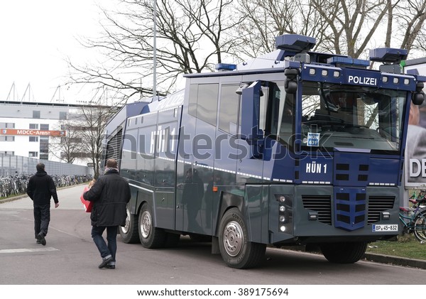      MAGDEBURG, GERMANY - MARCH 05, 2016:  increased\
police presence with water cannon during the football game 1.FC\
Magdeburg against FC Hansa Rostock in Front of the stadium         \
               