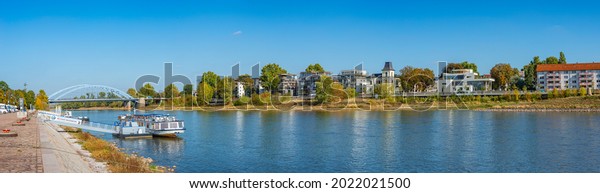 Magdeburg, Germany - September 27, 2018: Panoramic\
view over camping site for campers, tour boats at harbor and living\
modern houses at the downtown and Elbe river at Autumn, at blue sky\
sunny day
