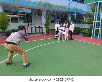 Magelang, Central Java, Indonesia - May 27, 2022:
Photographer Taking Student Photo For School Yearbook