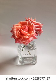 MAGELANG, INDONESIA - OCTOBER 8th, 2020 - DIY Vase Made From Zara Perfume Bottle With Beautiful Rose Flowers On White Background, Hand Made, Reuse And Recyle