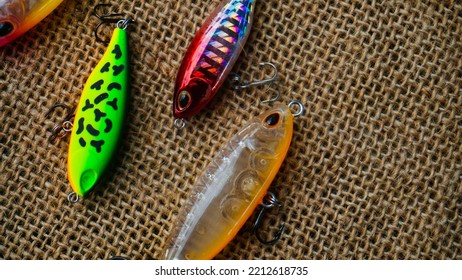 Magelang, Indonesia - October 9th 2022 : Artificial Lure Made From Plastic For Fishing By Casting. Casting Lure With Hook On The Burlap. Artificial Lure With The Shape Of Minnow - Flat Lay