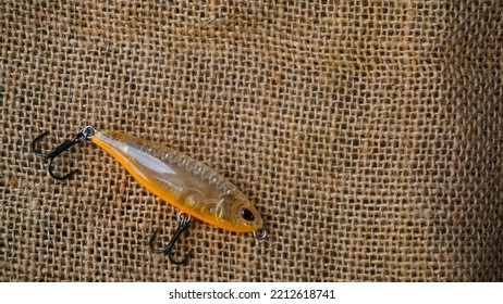 Magelang, Indonesia - October 9th 2022 : Artificial Lure Made From Plastic For Fishing By Casting. Casting Lure With Hook On The Burlap - Artificial Lure With The Shape Of Minnow
