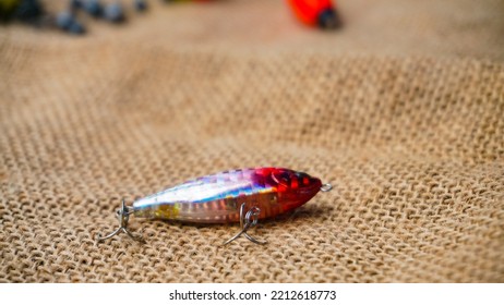 Magelang, Indonesia - October 9th 2022 : Artificial Lure Made From Plastic For Fishing By Casting. Casting Lure With Hook On The Burlap - Artificial Lure With The Shape Of Minnow