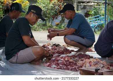 
Magelang, July 10, 2022 - Asian Men Cutting Beef During Eid Al-Adha Celebrations. Eid Al-Adha Is The Second And Bigger Of The Two Main Holidays Celebrated In Islam