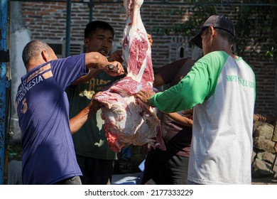 
Magelang, July 10, 2022 - Asian Men Cutting Beef During Eid Al-Adha Celebrations. Eid Al-Adha Is The Second And Bigger Of The Two Main Holidays Celebrated In Islam