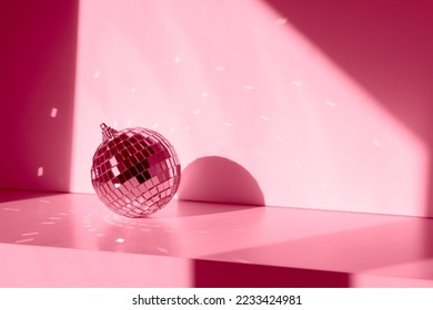 Magenta Disco ball in sunlight with reflections on white background. Geometric shadows - Powered by Shutterstock