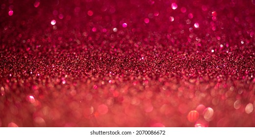 Magenta glitter lights. Shiny sparkles, bokeh effects, glowing surface. Selective focus, christmas abstract banner, background photo