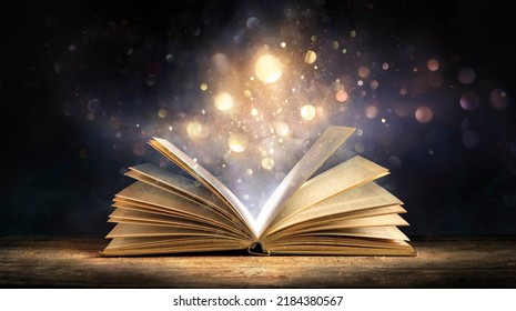 Magic Book With Open Antique Pages And Abstract Bokeh Lights Glowing In Dark Background - Literature And Education Concept - Shutterstock ID 2184380567