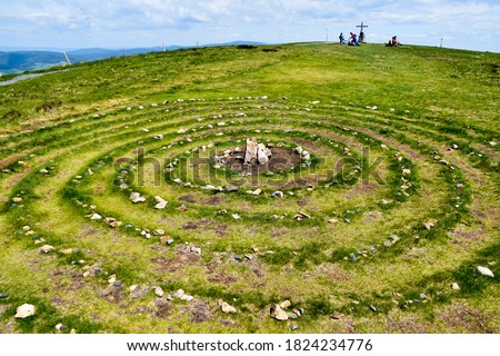 Magic Celtic spiral of life made of rocks in nature.