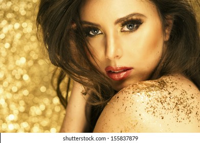 Magic Girl Portrait in Gold. Golden Makeup 