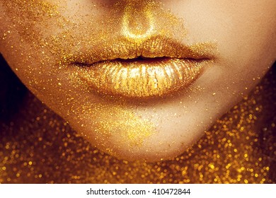 Magic Girl Portrait in Gold. Golden Makeup, close-up portrait in studio shot, color