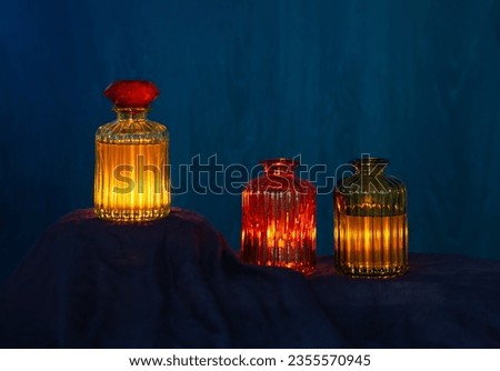 magic glowing  potions in glass bottles on dark background