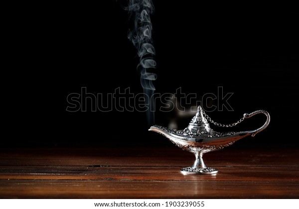 A magic lamp that makes dreams come\
true on a wooden table on an enchanting night\
