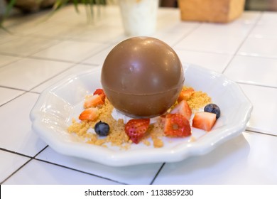 Magic Melting Chocolate Ball Wit Fruit On White Plate