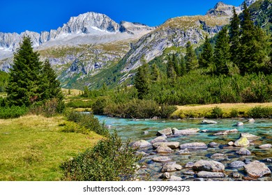 Magic montain river with summer mountains in Val di Fumo, in Adamello-Brenta National park. Blue sky upon a beautiful italian Dolomites mountains landscape with forest. Italian tourism