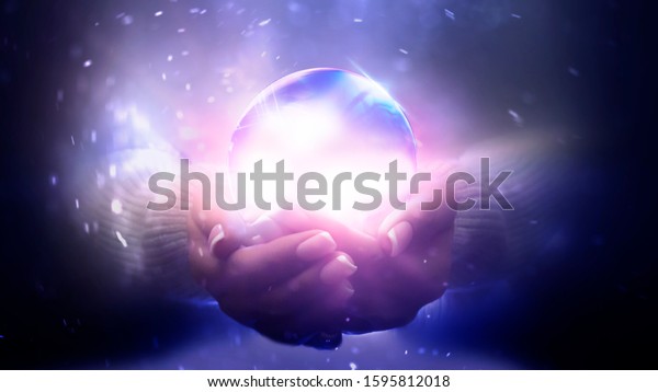 Magic\
particles emanating from female hands. Glass ball in the hands.\
Magic particles on the palms, magic,\
witchcraft.