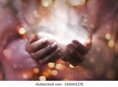 magic particles on the palms of a woman, the flow of magical energy emanating from female hands.