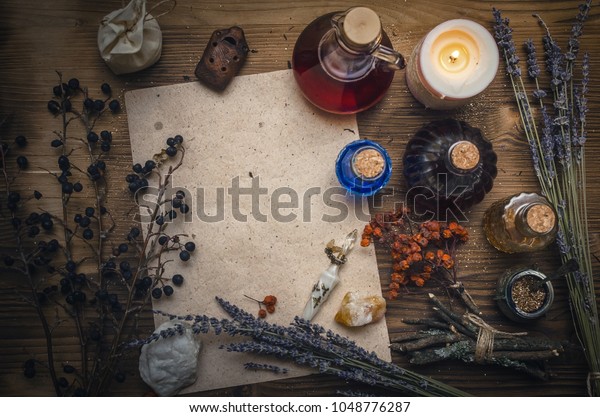 Magic potion ancient recipe
scroll with copy space. Alternative herbal medicine. Shaman table
with copy space. Druidism concept. Witch doctor desk
background.