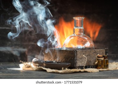 Magic potion on the table on burning fire in fireplace background. Alchemy concept.
