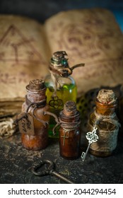 Magic potions in bottles, ancient books and witchery herbs on wooden background, Halloween theme - Shutterstock ID 2044294454