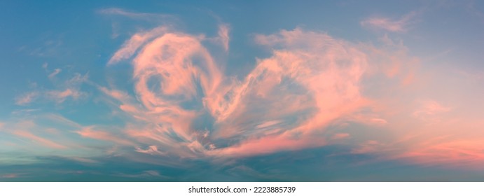 Magic real heart made from clouds in the sunset sky. Pink light heart shaped clouds. Love. Panoramic sky for Valentine's Day, Wedding, Mother's Day. Holidays of love and tenderness - Powered by Shutterstock