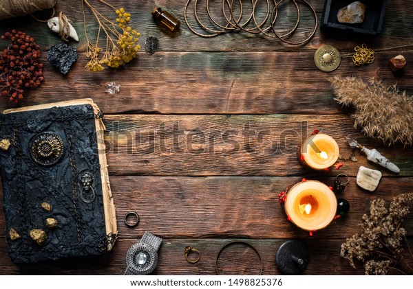 Magic\
recipe book and a magic potions on a table. Witchcraft background\
with copy space. Druid or witch doctor\
table.