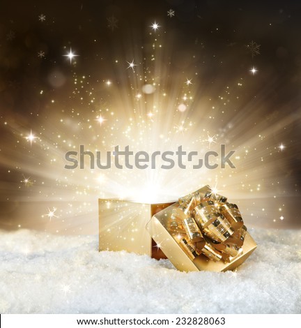 magic shining of christmas gift - golden stardust and snow.