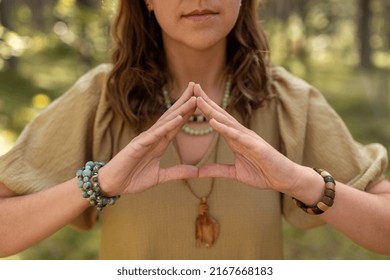 Magic, Spirituality And Supernatural Concept - Close Up Of Woman Or Witch Making Triangle Of Power Gesture In Forest