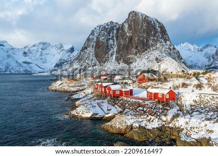 Magic sunlight hitting the small houses and the mountains at the village Hamnoy, Lofoten, Norway in middle of the winter.