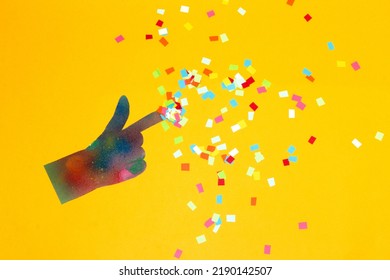 Magic Touch, Creative Art Design On A Yellow Background, Colorful Hand With Colorful Paper Scattered Around