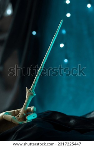 Magic wand artifact in wooden hand