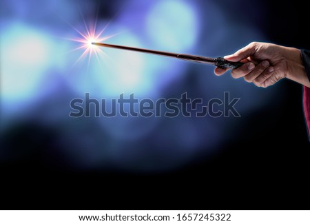 Magic wand with sparkle on blue background, Miracle magical stick Wizard tool on hot blue.